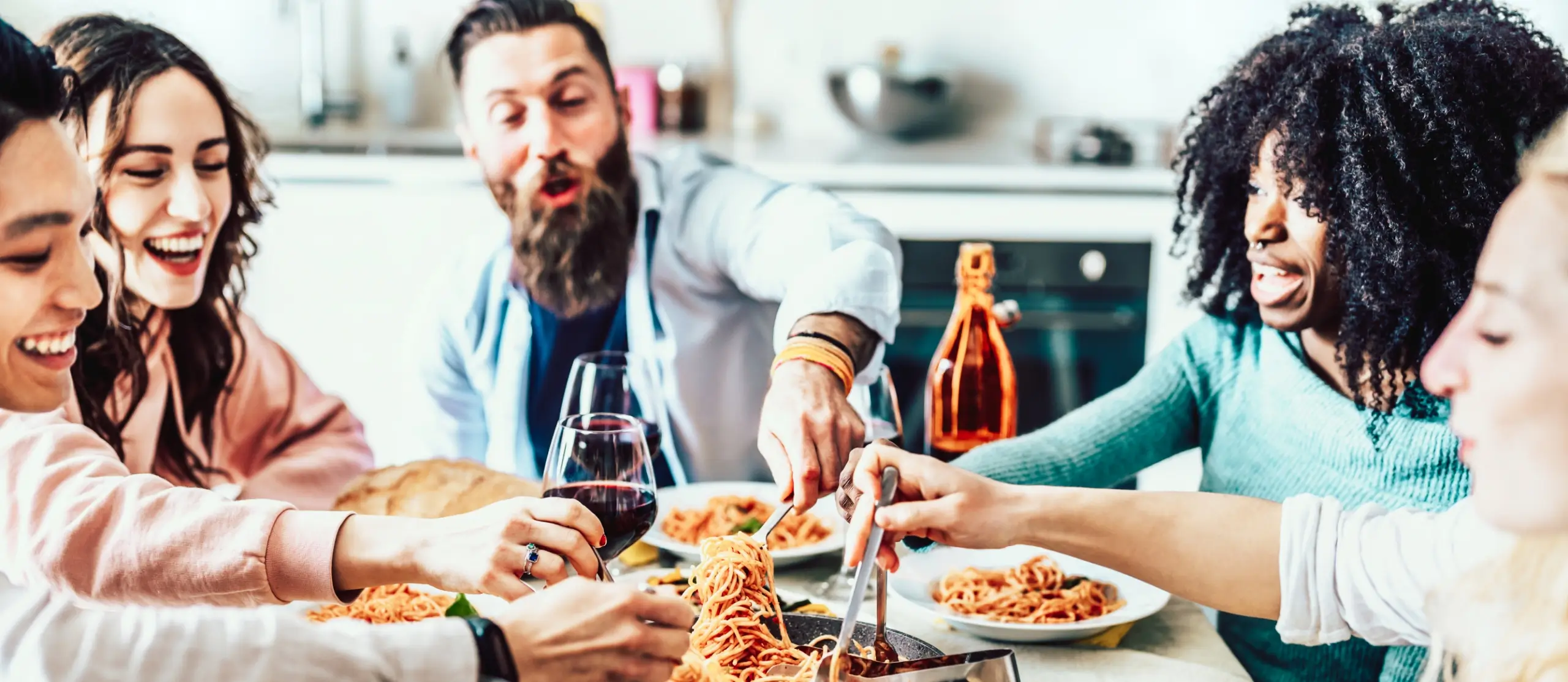 Group of friends eating spaghetti